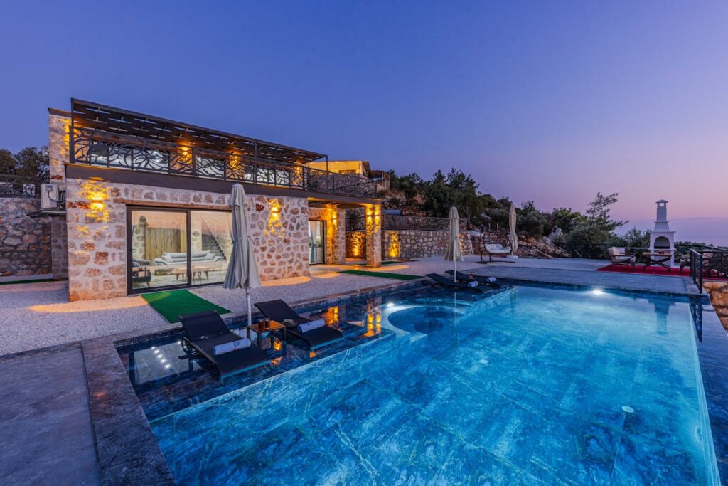 pexels photo 28054849 Elegant stone villa with infinity pool offers serene vacation vibes at twilight.