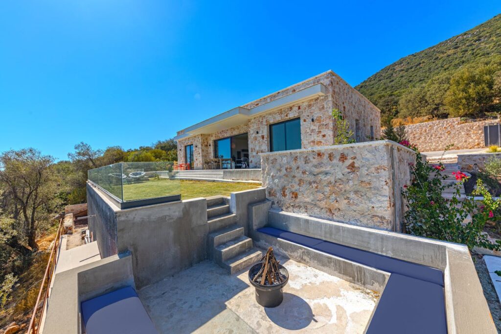 pexels photo 28054862 2 Modern stone villa with glass accents in a sunny and scenic summer setting, ideal for travel and relaxation.